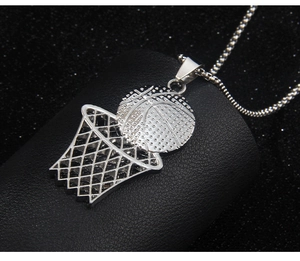 Detailed close-up of a silver basketball hoop pendant on textured black leather