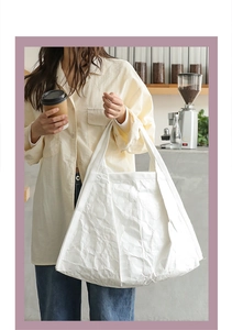 Detailed texture of white crumpled DuPont paper on a stylish casual tote bag