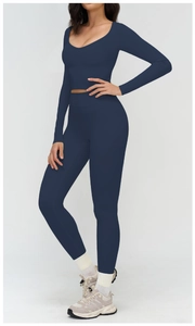 Detail of dark blue yoga set featuring a deep U-neck crop top and high-waisted leggings