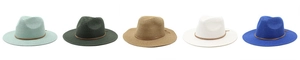 Flat lay of five assorted colors of woven straw fedora hats with slim leather bands