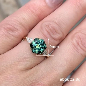 Luxury gold ring for women featuring a 9mm hexagonal green gemstone and pear side diamonds