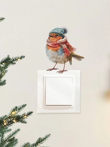 Détail d'un autocollant mural d'oiseau de Noël avec bonnet bleu au-dessus d'un interrupteur