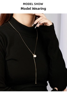 Elegant Y-shaped adjustable sterling silver necklace with baroque pearl on a black sweater