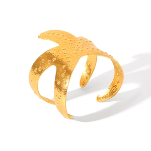 Macro shot of 18K gold plated starfish cuff bracelet with unique hammered texture finish