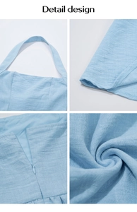 Detail view of light blue linen dress showing halter neckline and invisible zipper design