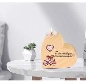 Macro shot of a wooden heart candle holder with English poem and warm tea light