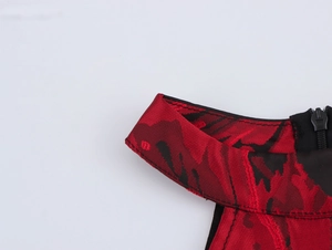 Macro detail of red and black jacquard fabric with a concealed zipper and fine stitching