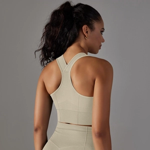 Close-up of ribbed seamless sports bra racerback and matching high-waisted leggings in sand