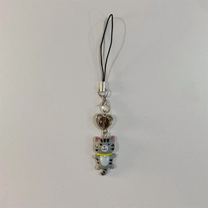 Close-up of grey and white striped resin cat keychain with a silver heart charm