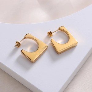 Polished 18k gold plated stainless steel geometric square stud earrings on a white stand
