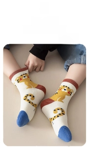 Close-up of high-elasticity baby winter socks with tiger jacquard and reinforced cuffs