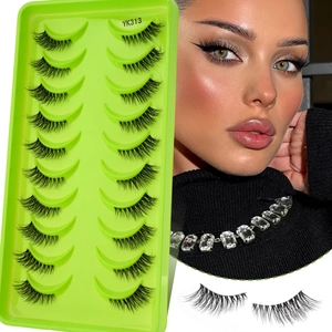 Detailed view of 10 pairs of dense curly false eyelashes with clear bands on green tray