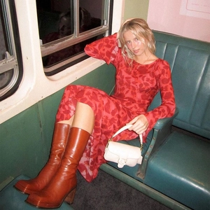 Detail of red printed long sleeve maxi dress paired with brown leather boots