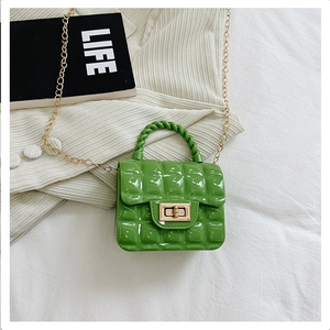 Detail of lime green quilted jelly bag with gold metal chain and twist-lock closure