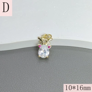 Macro view of gold elk pendant with pear-shaped zircon and pink stones, 10x16mm detail