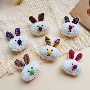 Detail showing colorful plaid ears on white plush bunny heads for DIY crafts and accessories
