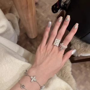 Vintage style square pearl ring with silver bracelets worn by a model in daily life