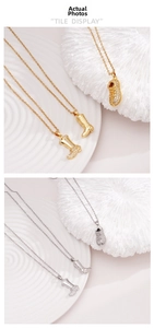 Detailed close-up of boot-shaped pendants in gold and silver with shimmering stones