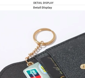 Detail view of black glitter wallet with gold snap button, key chain and card slots