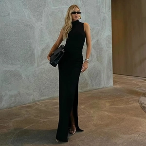 Detail of high side slit and ruched texture on a slim-fit black sleeveless maxi dress