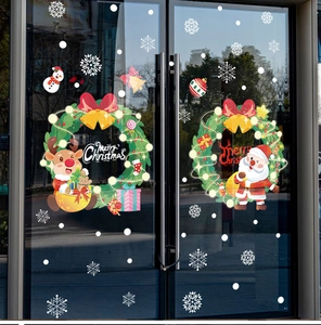 Christmas window stickers with Santa, reindeer and snowflakes on glass storefront displays