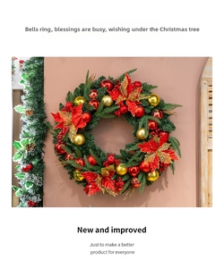 Close-up of a 50cm Christmas wreath with red poinsettias and golden ornaments on a wall