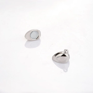 Close-up of silver-plated heart magnetic clasps for jewelry making with reflections