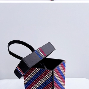 Macro detail of luxury evening bag featuring colorful rhinestones and striped pattern