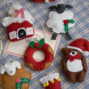 Handmade Christmas felt ornaments set with mini reindeer, house and wreath on plaid fabric