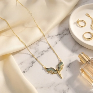 Macro view of 18K gold plated wing necklace pendant with shimmering colorful zircons