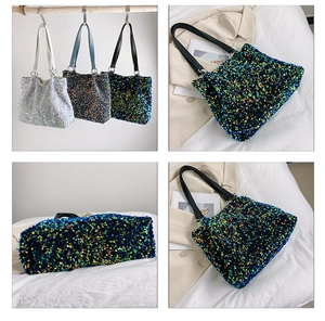 Close-up of sparkling sequin bucket bag with colorful reflections and black shoulder strap