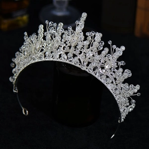 Detailed view of silver bridal crown with shimmering crystals and floral bead patterns
