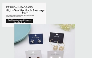 Detail of white display cards showcasing star-shaped studs and golden nest earrings
