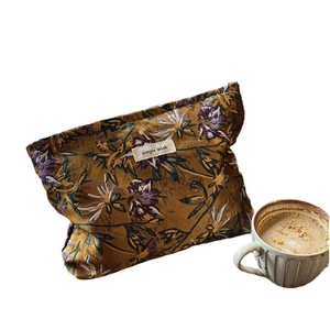 Caramel floral jacquard cosmetic bag with 'simple wish' tag and vintage fabric pattern