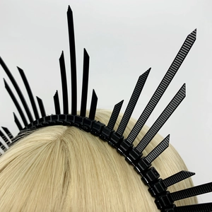 Detail of a black gothic spiked halo crown headband on a blonde wig for costumes