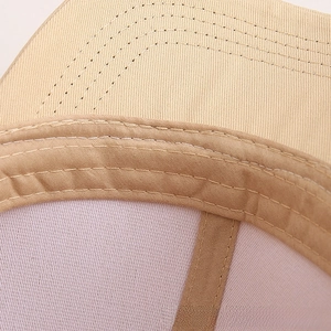 Close-up of khaki cotton baseball cap interior with Pink mesh lining and double stitching