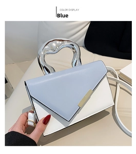 Detail of blue and white crossbody bag with unique liquid metal silver handle and buckle