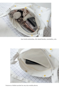 Detail of white daisy tote bag showing large capacity for A4 books and interior pocket
