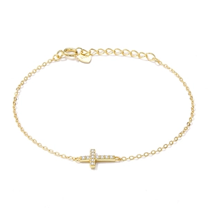 Close-up of gold-plated cross bracelet with crystals and heart-shaped S925 tag