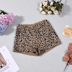 Detailed view of sequined leopard print shorts with textured faux fur finish on flat lay