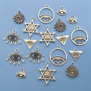 Silver alloy Eye of Horus and Hamsa Hand charms set displayed on a blue background