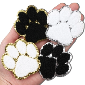 Black and white chenille dog paw patches with gold and silver glitter embroidery edges