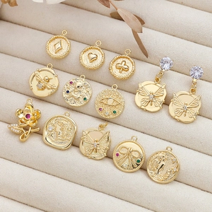Macro shot of gold-plated vintage charms with colorful zircon inlays for jewelry making