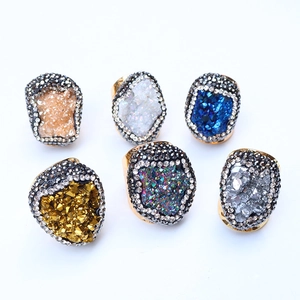Detailed view of six colorful druzy crystal geode rings with rhinestone micro-pave borders