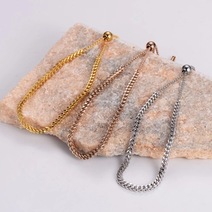 Minimalist adjustable woven chain bracelets in gold, rose gold and silver on stone