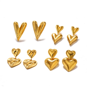 Set of four unique 18K gold plated stainless steel heart earrings on a white background