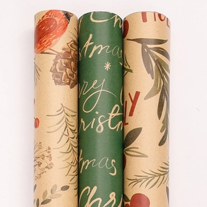 Three rolls of Christmas kraft wrapping paper with vintage birds, pine cones, and berry patterns