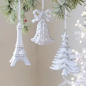 White flocked Christmas tree ornaments set with Eiffel Tower bell and star designs