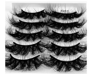 Macro shot of 5 pairs thick messy lashes G01 on a white tray showing density and curl