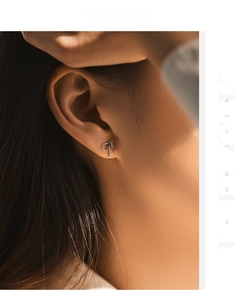 Close-up of s925 silver bow stud earrings with twisted texture worn by a model